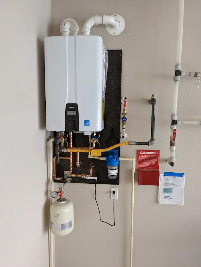 Professional plumber installing copper piping in a Colonie home